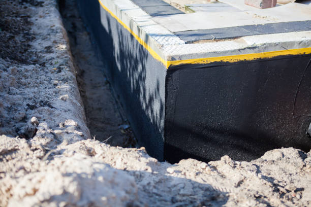Professional Basement Waterproofing technician working in Spencerville, IN